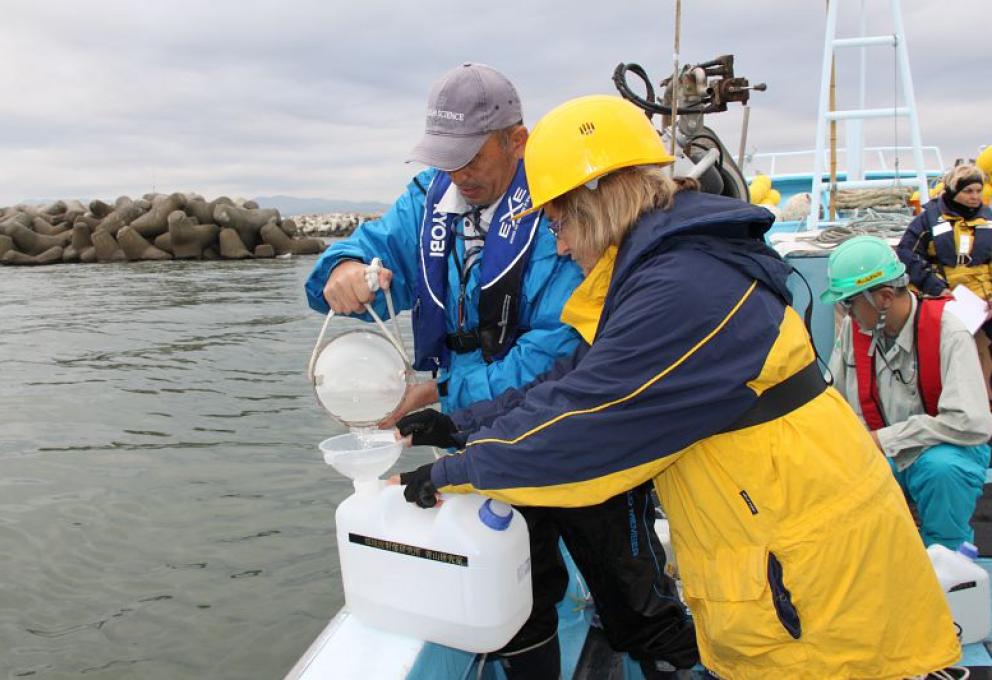 Sabine Charmasson, chercheuse en radioécologie au Laboratoire d'études radioécologiques en milieu continental et marin (LERCM), et l'équipe du l'Institute of Environmental Radioactivity de l'Université de Fukushima, filtrent l'eau de mer prélevée.Au fond à droite, Mirelle Arnaud, chercheuse au LERCM  - © Médiathèque IRSN